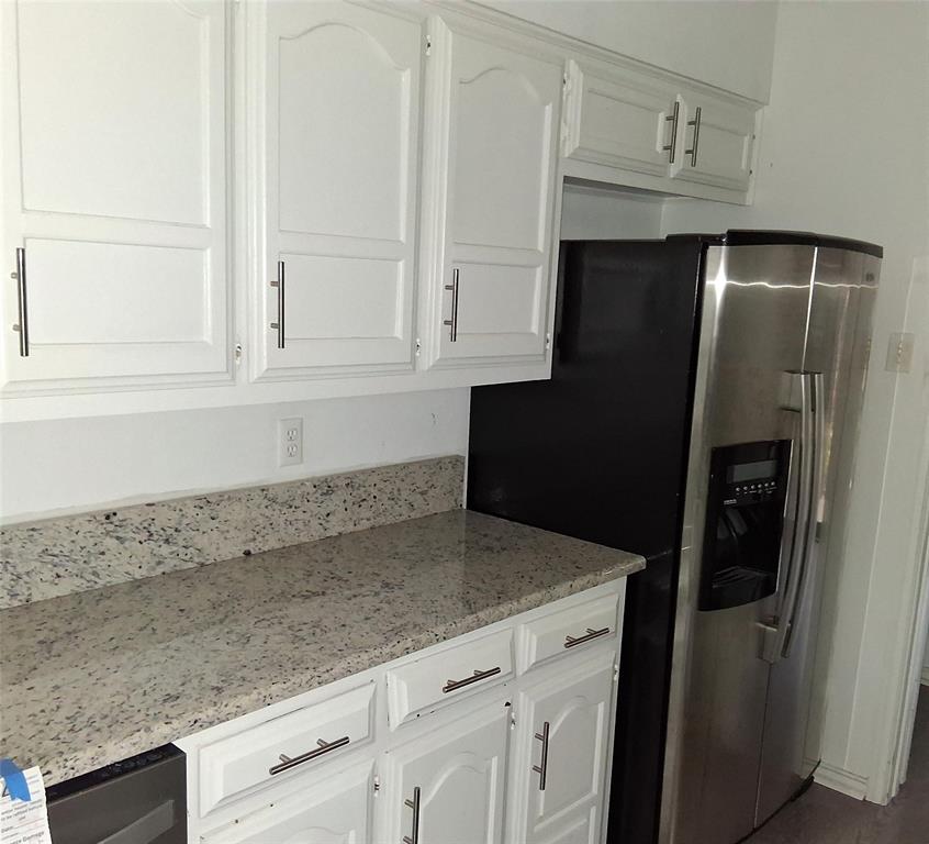814 Oakbluff Drive Lancaster, TX 75146 - Photo 6 of 17 a kitchen with granite countertop white cabinets and stainless steel appliances