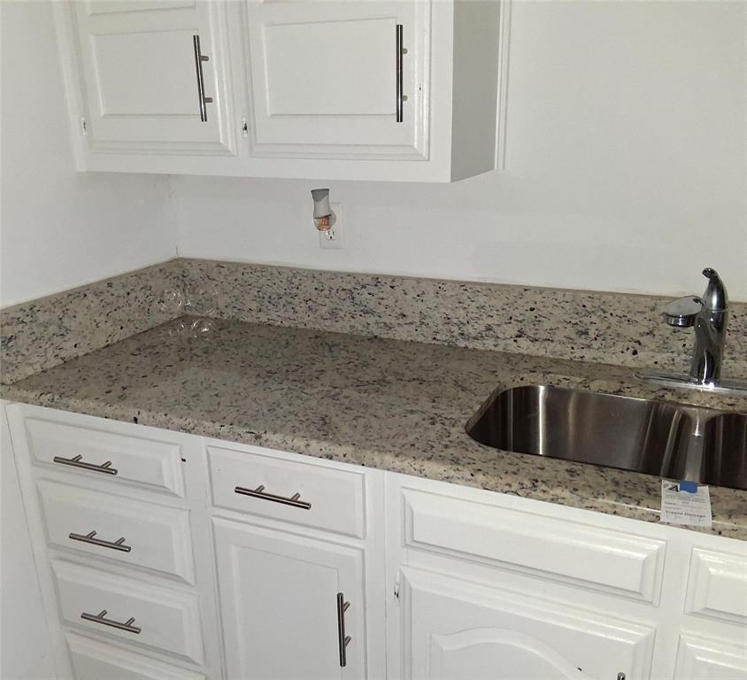 814 Oakbluff Drive Lancaster, TX 75146 - Photo 7 of 17 a kitchen with white cabinets and sink