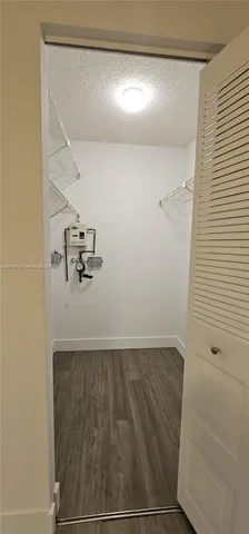 a view of storage and utility room with racks on the wall