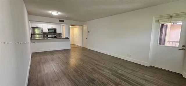 a view of a kitchen with a sink and a stove top oven