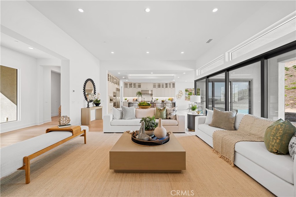 a living room with fireplace furniture and a large window