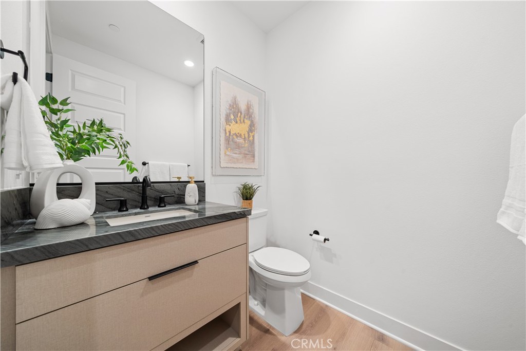 18302 Saddle Crest Silverado, CA 92676 - Photo 10 of 40 a bathroom with a granite countertop sink a toilet and mirror