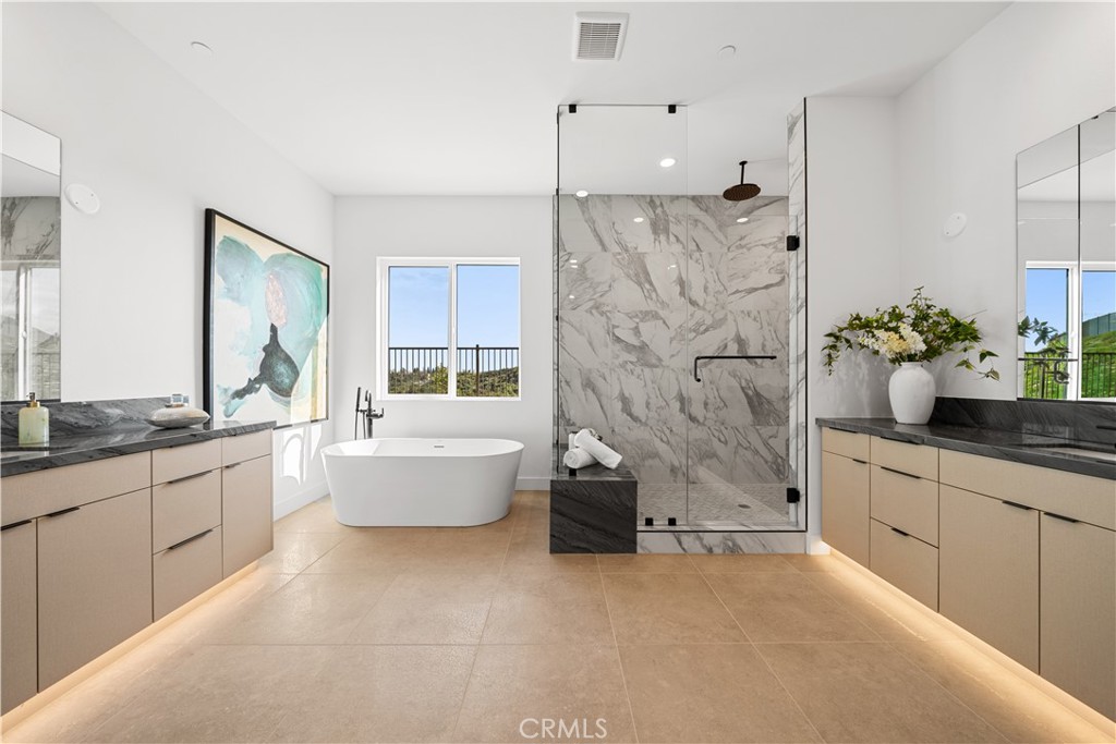 18302 Saddle Crest Silverado, CA 92676 - Photo 16 of 40 a bathroom with a granite countertop tub sink and mirror
