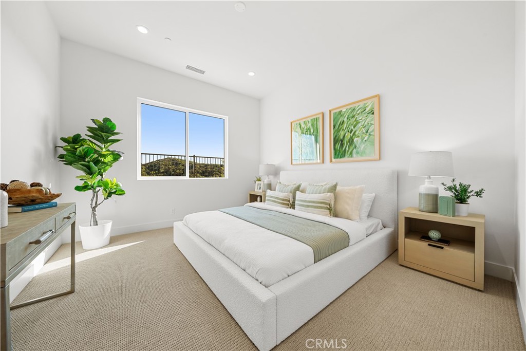 18302 Saddle Crest Silverado, CA 92676 - Photo 20 of 40 a room with a bed window and potted plant