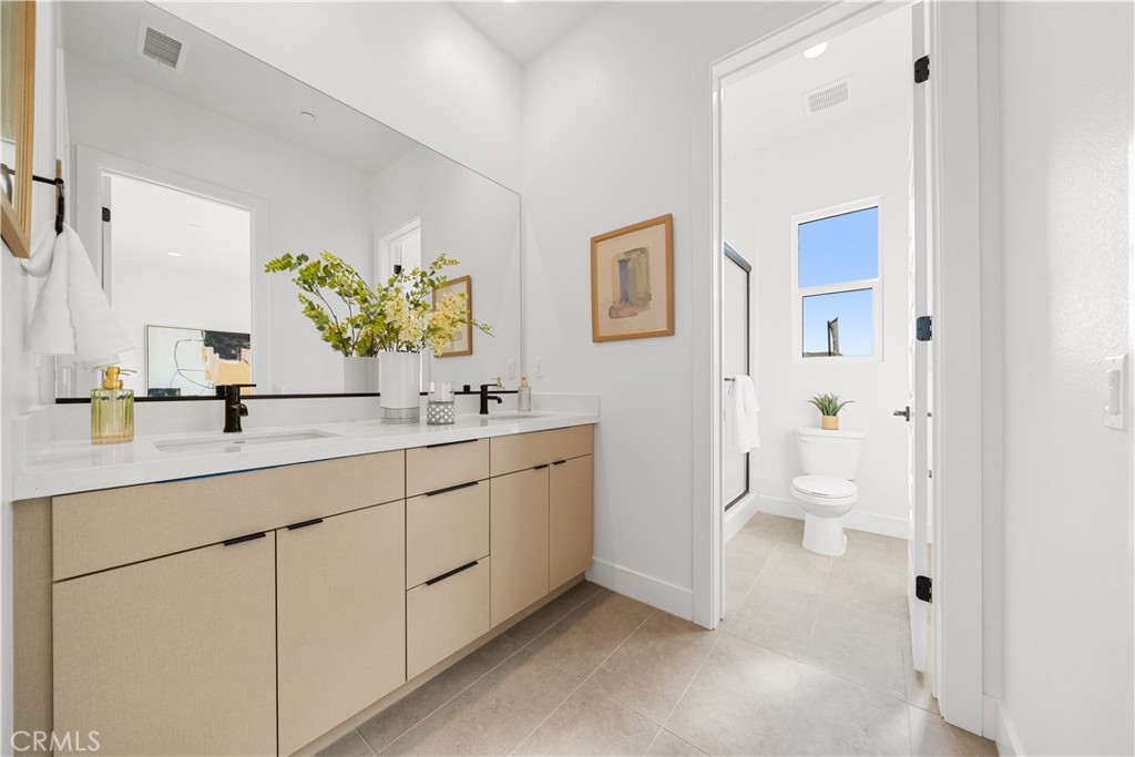 18302 Saddle Crest Silverado, CA 92676 - Photo 24 of 40 a bathroom with a double vanity sink toilet and a mirror