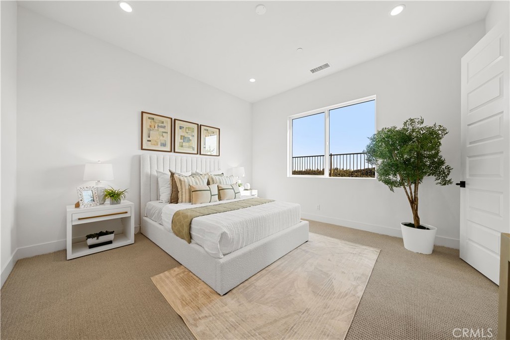 18302 Saddle Crest Silverado, CA 92676 - Photo 25 of 40 a bed room with a bed and a potted plant