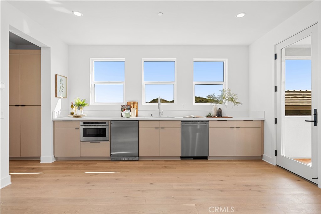 18302 Saddle Crest Silverado, CA 92676 - Photo 31 of 40 a kitchen with a sink stove and cabinets
