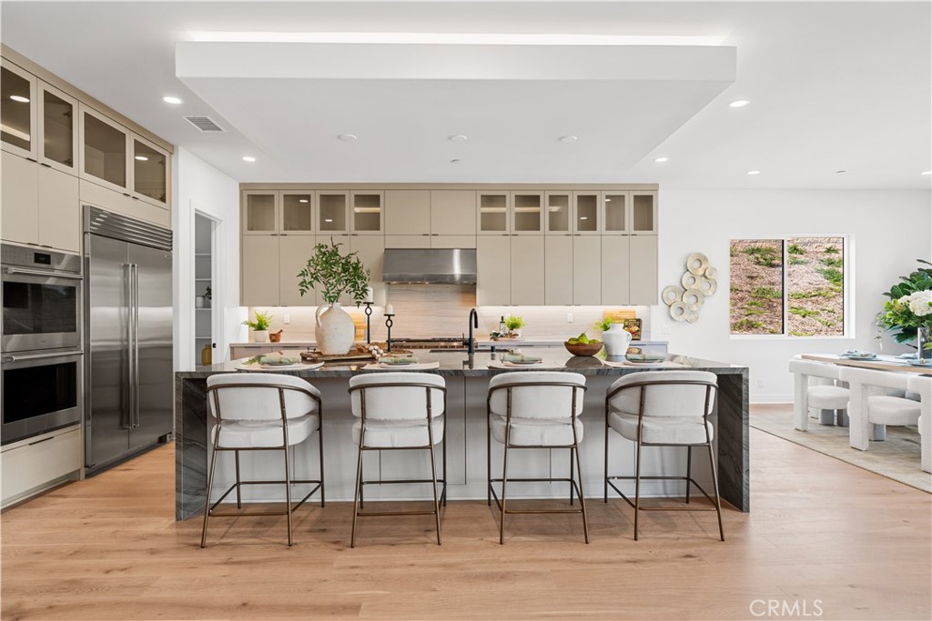 18302 Saddle Crest Silverado, CA 92676 - Photo 7 of 40 a kitchen with stainless steel appliances granite countertop a table and chairs in it