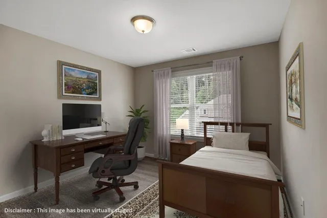 a view of a workspace with furniture and a window