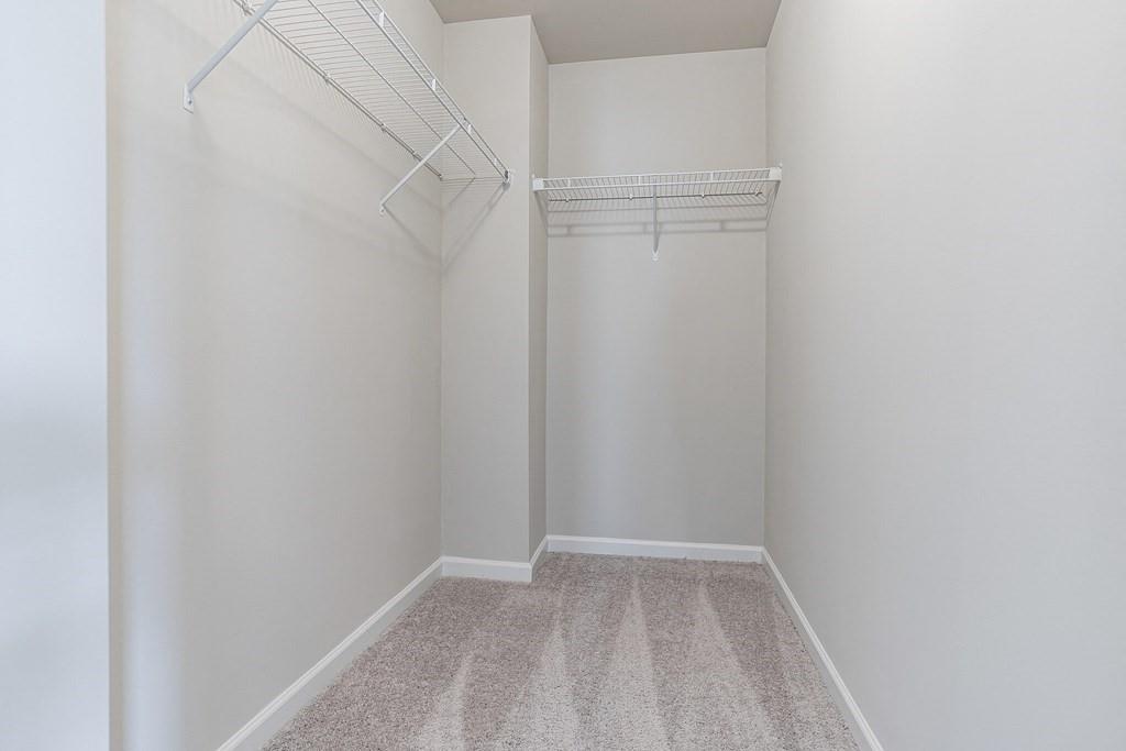 1852 Auburn Road, Unit GRANTVIEW Dacula, GA 30019 - Photo 19 of 31 a view of an empty walk in closet