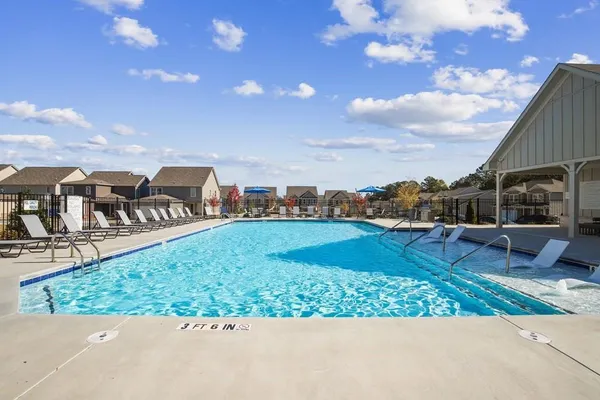 a view of a swimming pool with an outdoor seating