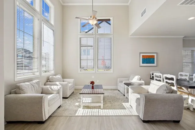 a living room with furniture a table and a large window