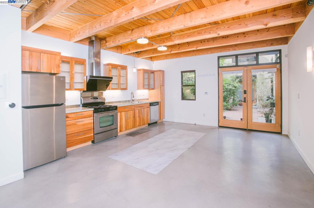 a kitchen with stainless steel appliances a refrigerator and a stove