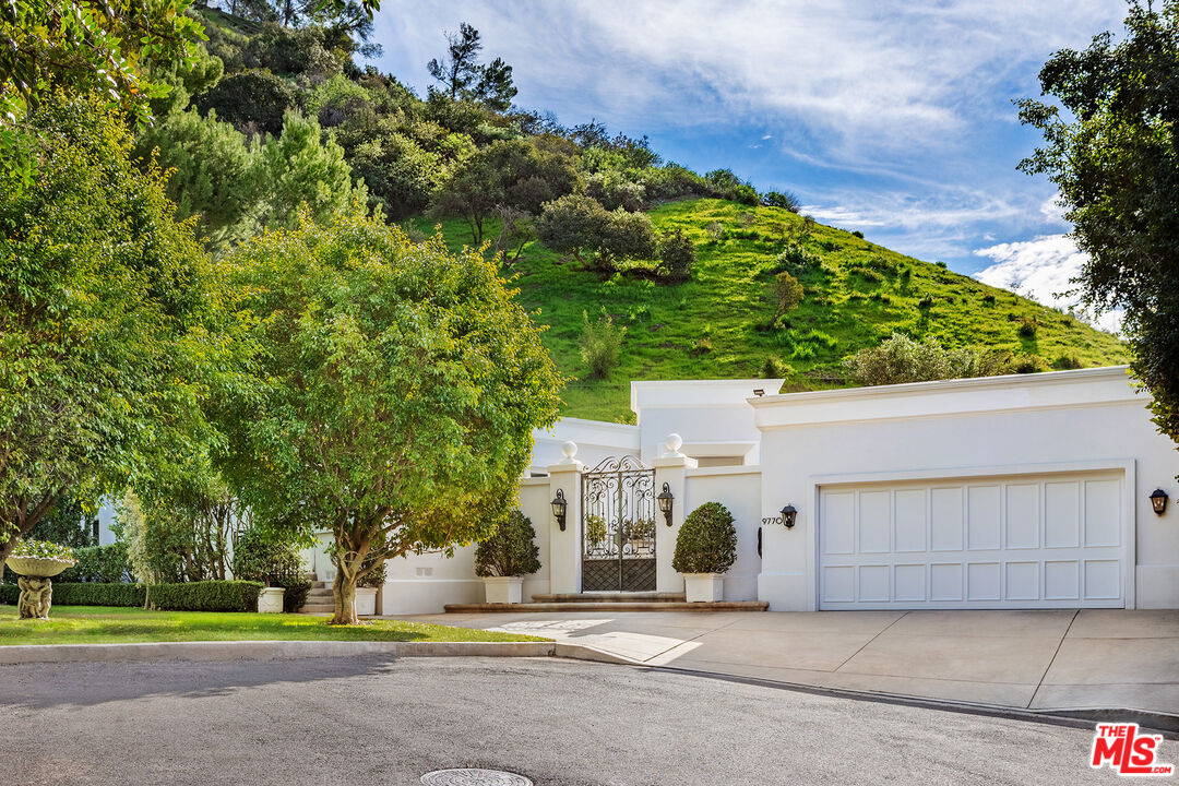 9770 San Circle Beverly Hills, CA 90210 - Photo 1 of 29 front view of a house with a yard and potted plants