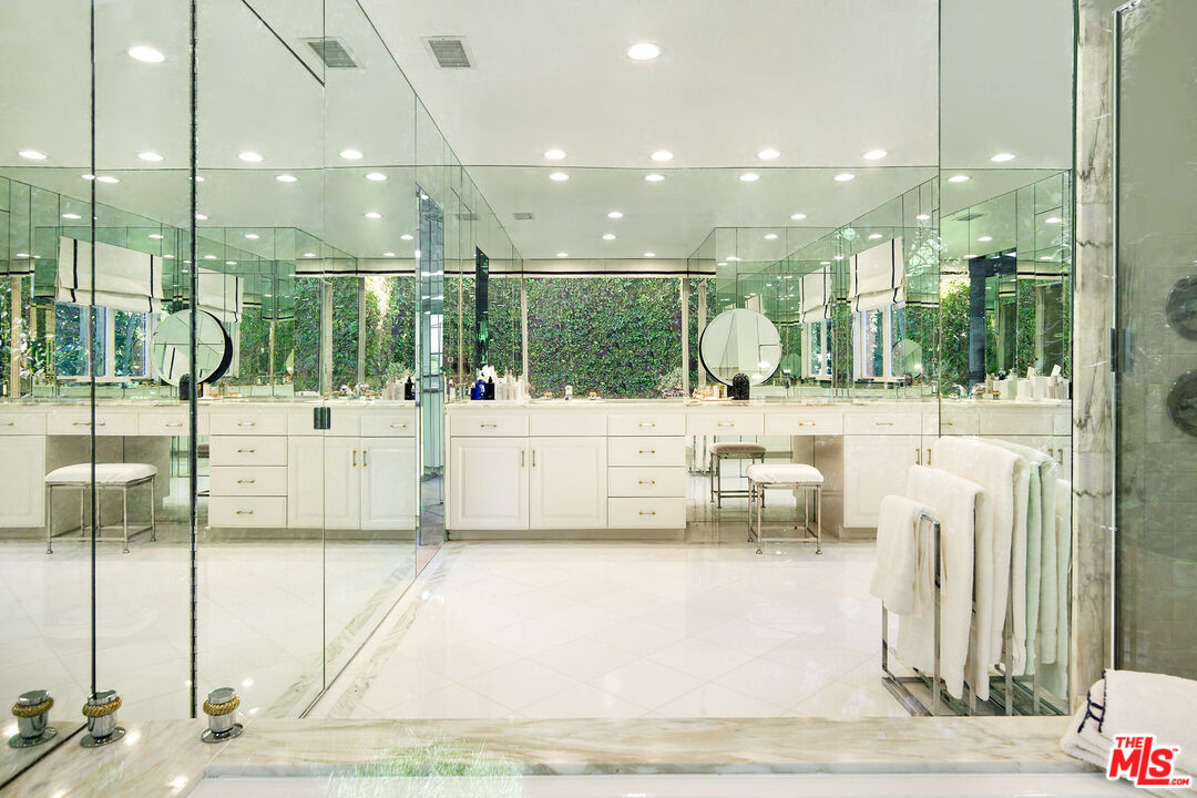 9770 San Circle Beverly Hills, CA 90210 - Photo 15 of 29 a bathroom with a sink a mirror and shower