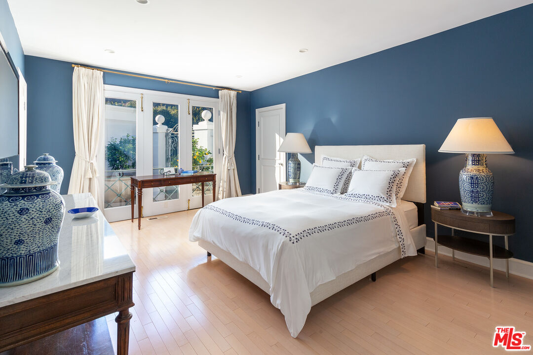 9770 San Circle Beverly Hills, CA 90210 - Photo 16 of 29 a bedroom with a bed and wooden floor