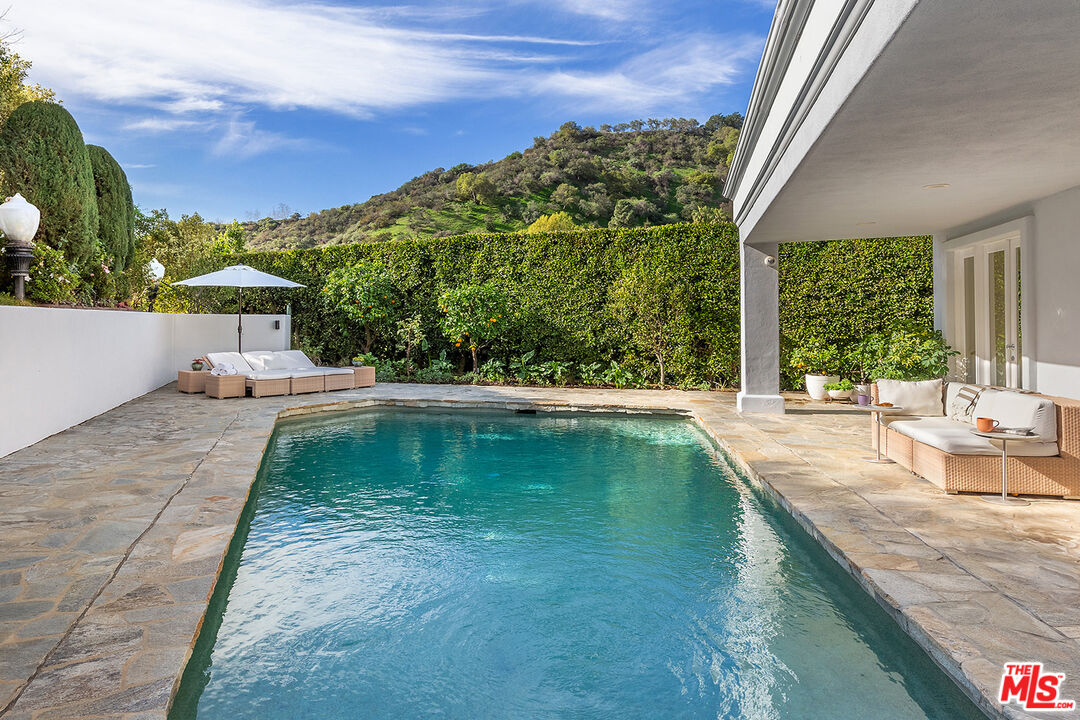 9770 San Circle Beverly Hills, CA 90210 - Photo 21 of 29 a view of a swimming pool with a patio