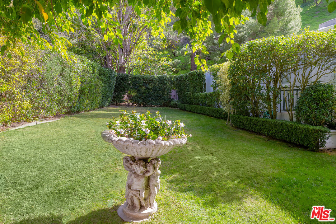 9770 San Circle Beverly Hills, CA 90210 - Photo 23 of 29 a view of a garden with a fountain