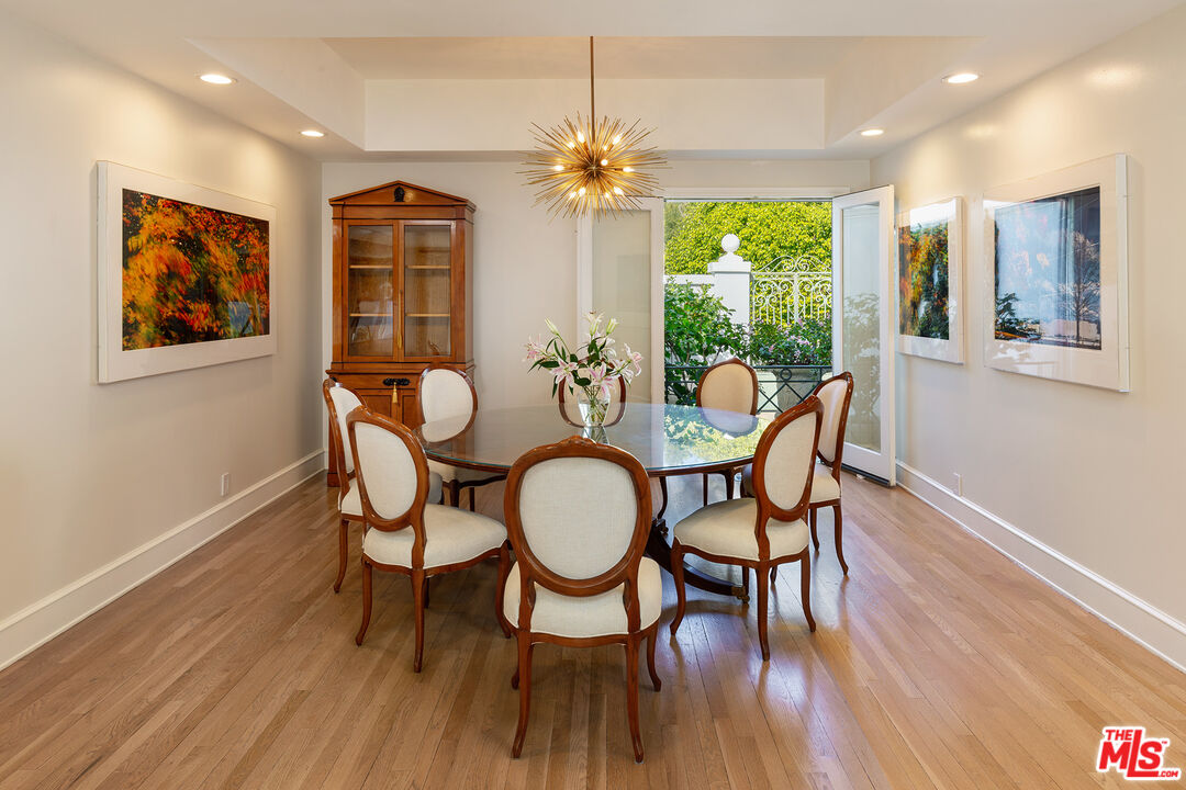 9770 San Circle Beverly Hills, CA 90210 - Photo 10 of 29 a dining room with furniture a large window and wooden floor