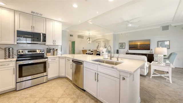 a view of a dining room with furniture and a chandelier