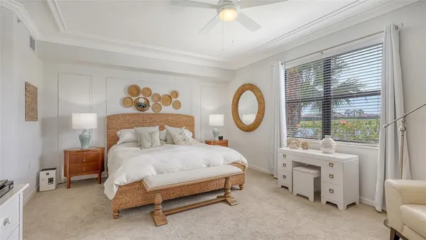 a large bed sitting in a bedroom next to a window