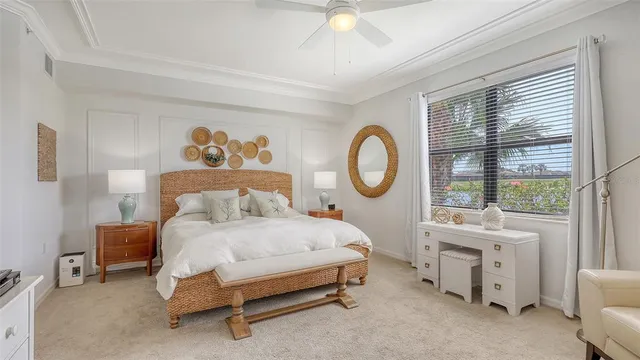 a large bed sitting in a bedroom next to a window