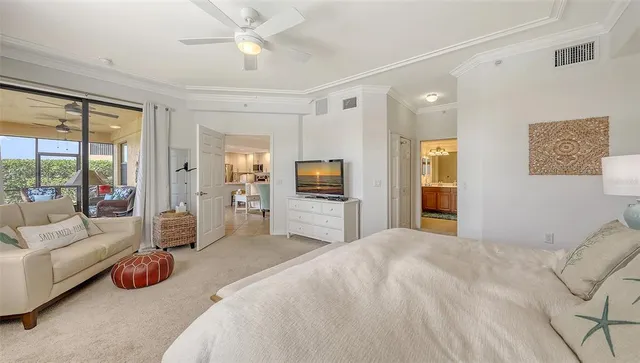 a living room with furniture and a floor to ceiling window