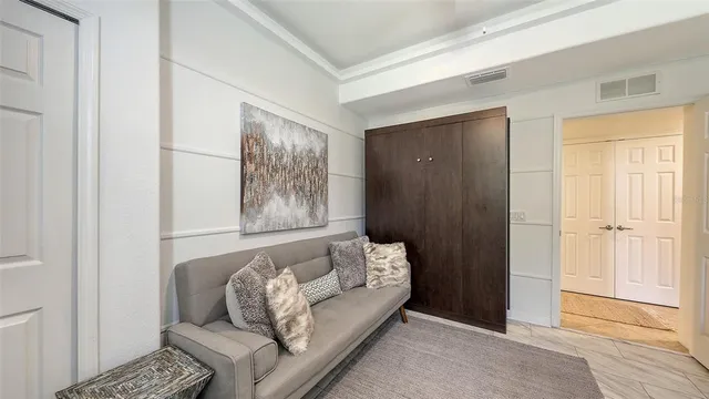 a living room with furniture a chandelier and a flat screen tv