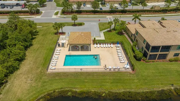 a front view of house with yard and swimming pool