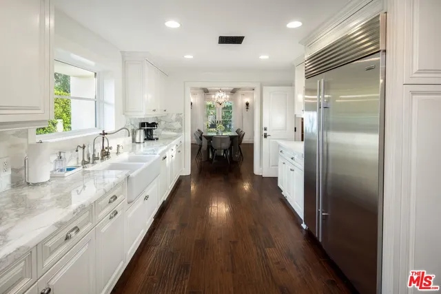 a large white kitchen with a large window
