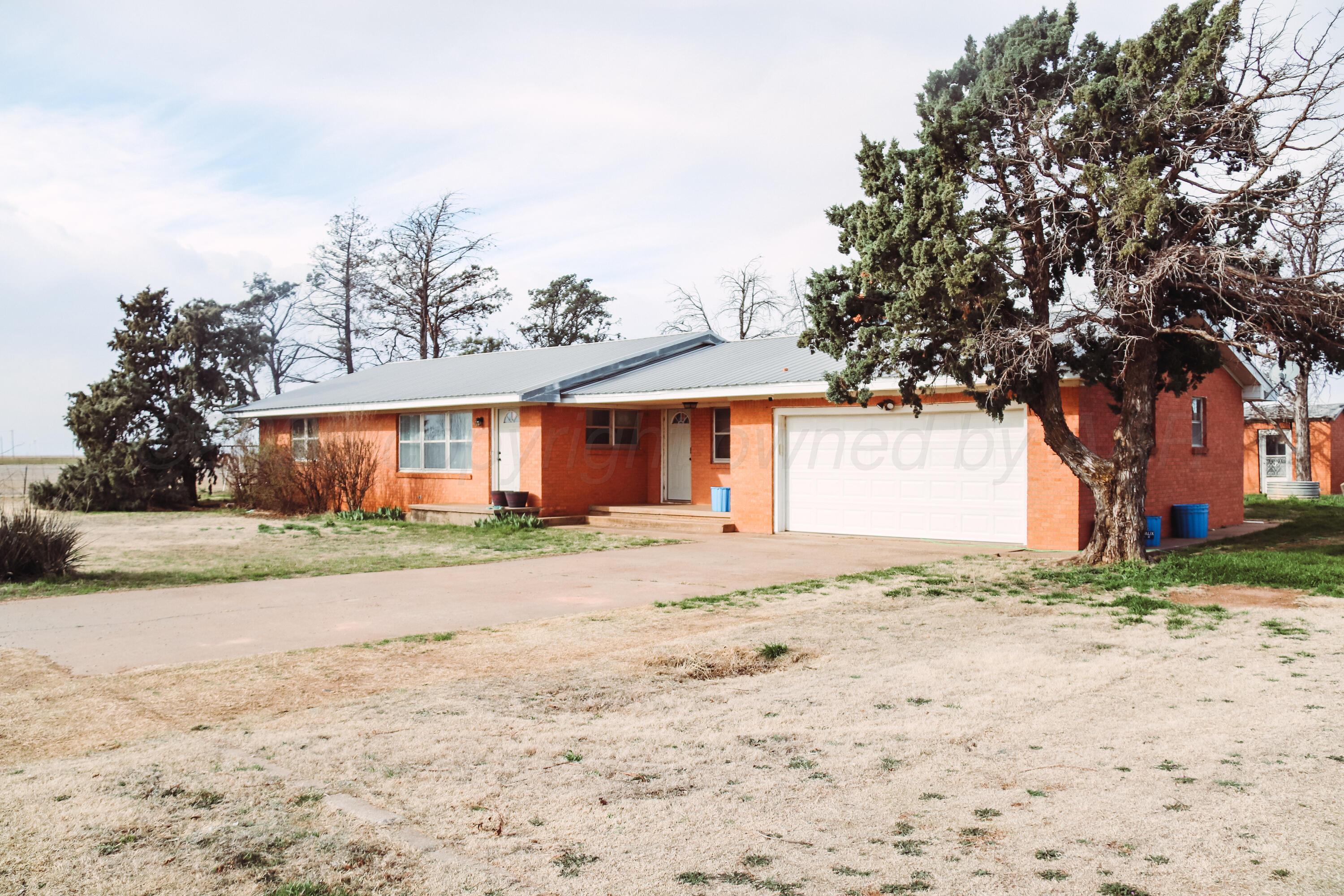1020 Highway 207 Floydada, TX 79235 - Photo 12 of 17 a front view of a house with a yard and garage