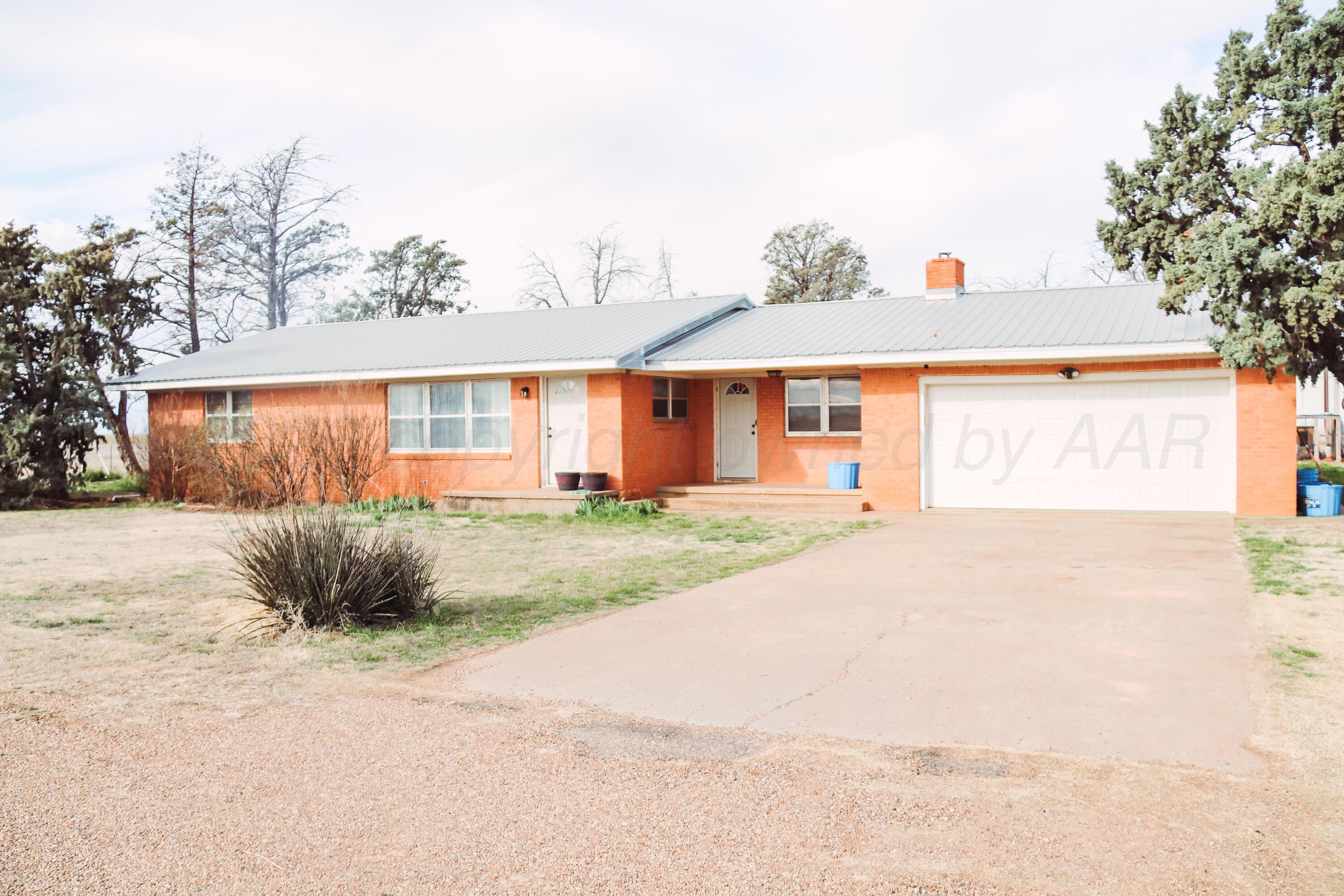 1020 Highway 207 Floydada, TX 79235 - Photo 14 of 17 a view of a white house next to a road and yard