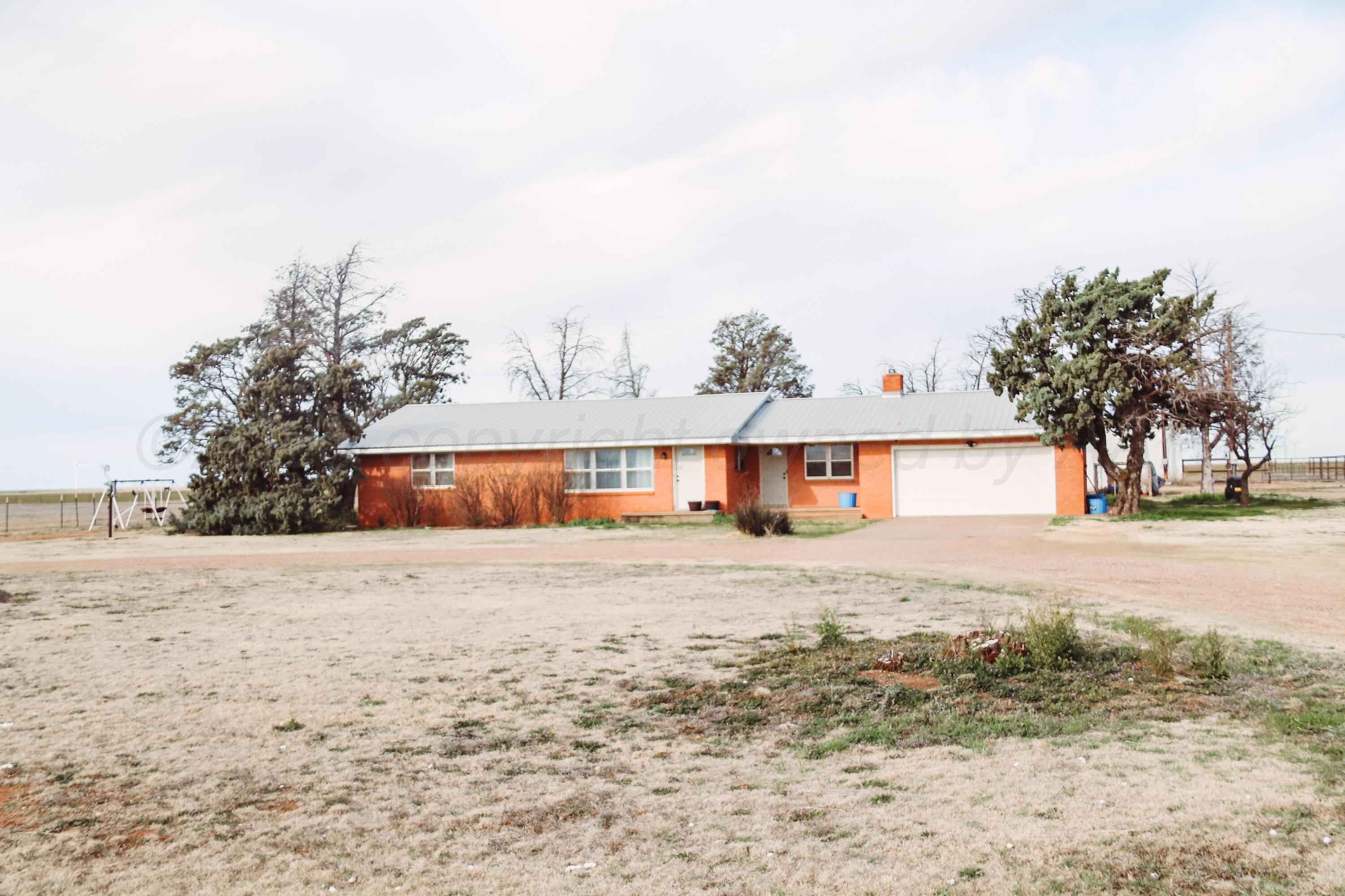 1020 Highway 207 Floydada, TX 79235 - Photo 17 of 17 a front view of a house with a yard and garage
