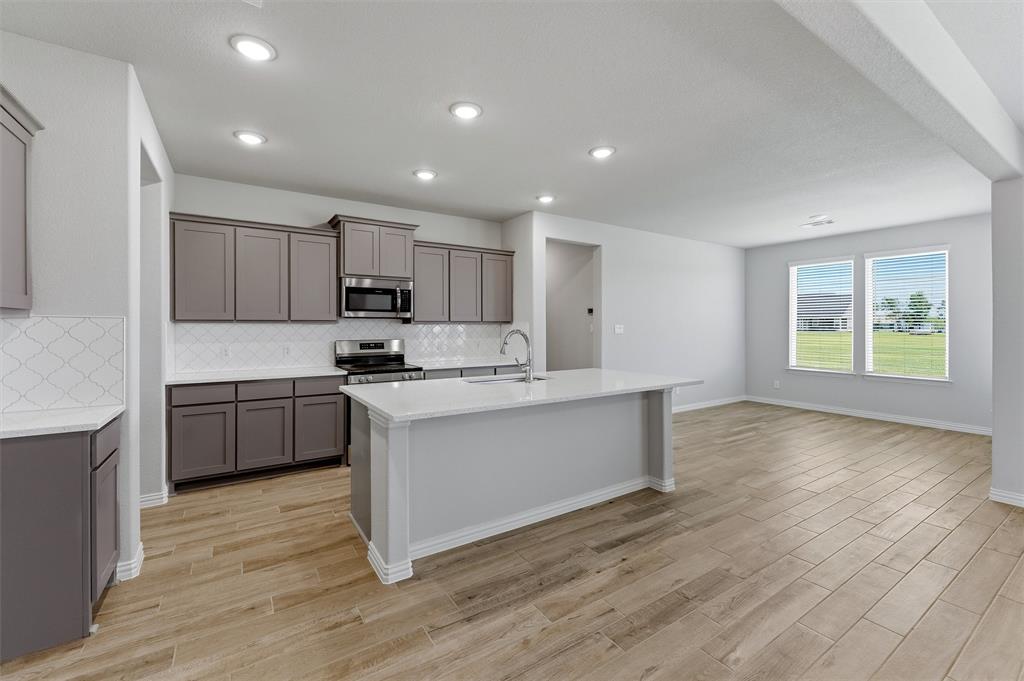 2627 Witness Tree Road Terrell, TX 75161 - Photo 8 of 27 a kitchen with stainless steel appliances granite countertop a stove a sink and a refrigerator