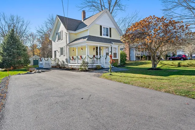 a front view of building with yard and green space