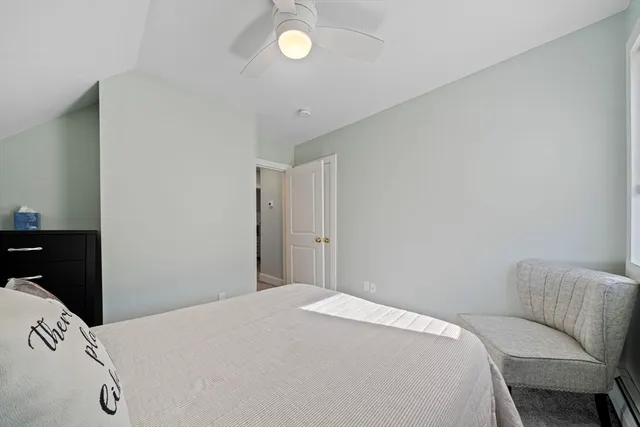 a bedroom with a bed and a chair