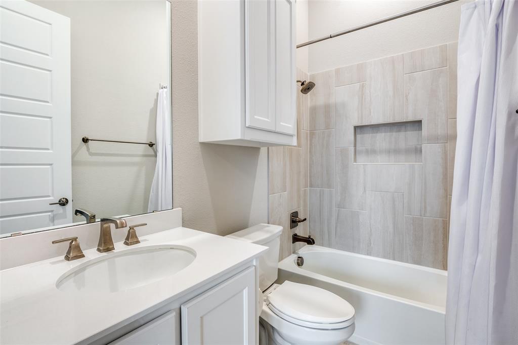 2901 Quinton Street Prosper, TX 75078 - Photo 19 of 27 a bathroom with a sink toilet and shower