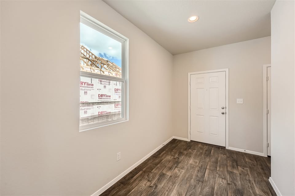 141 Bluestem Drive Elgin, TX 78621 - Photo 9 of 19 an empty room with wooden floor and windows