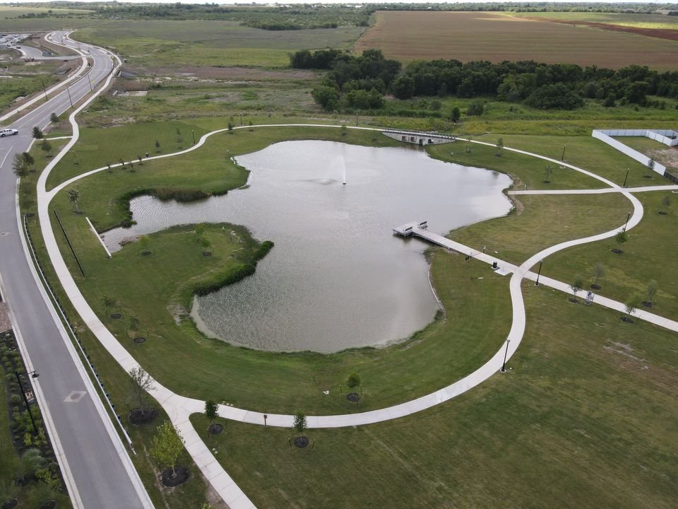 141 Bluestem Drive Elgin, TX 78621 - Photo 15 of 19 a view of a swimming pool with a lake view and sitting space