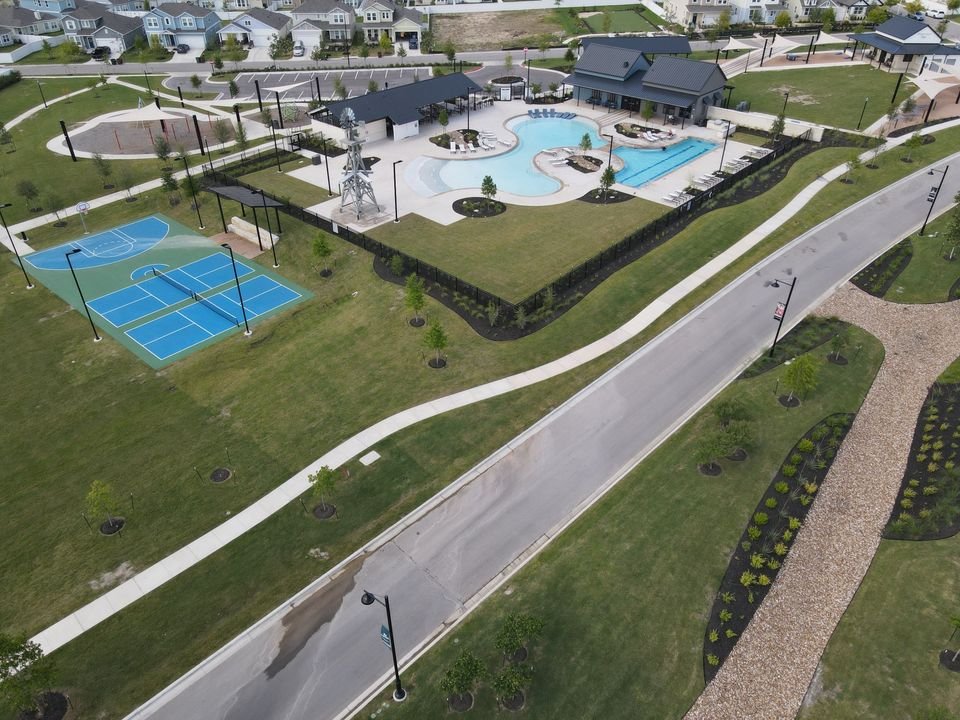 141 Bluestem Drive Elgin, TX 78621 - Photo 16 of 19 a view of a pool with chairs