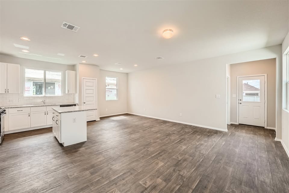 141 Bluestem Drive Elgin, TX 78621 - Photo 19 of 19 a view of a kitchen with wooden floor and a sink