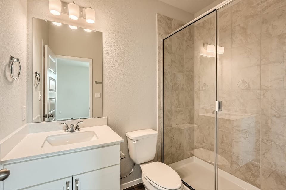 141 Bluestem Drive Elgin, TX 78621 - Photo 7 of 19 a bathroom with a sink toilet and shower