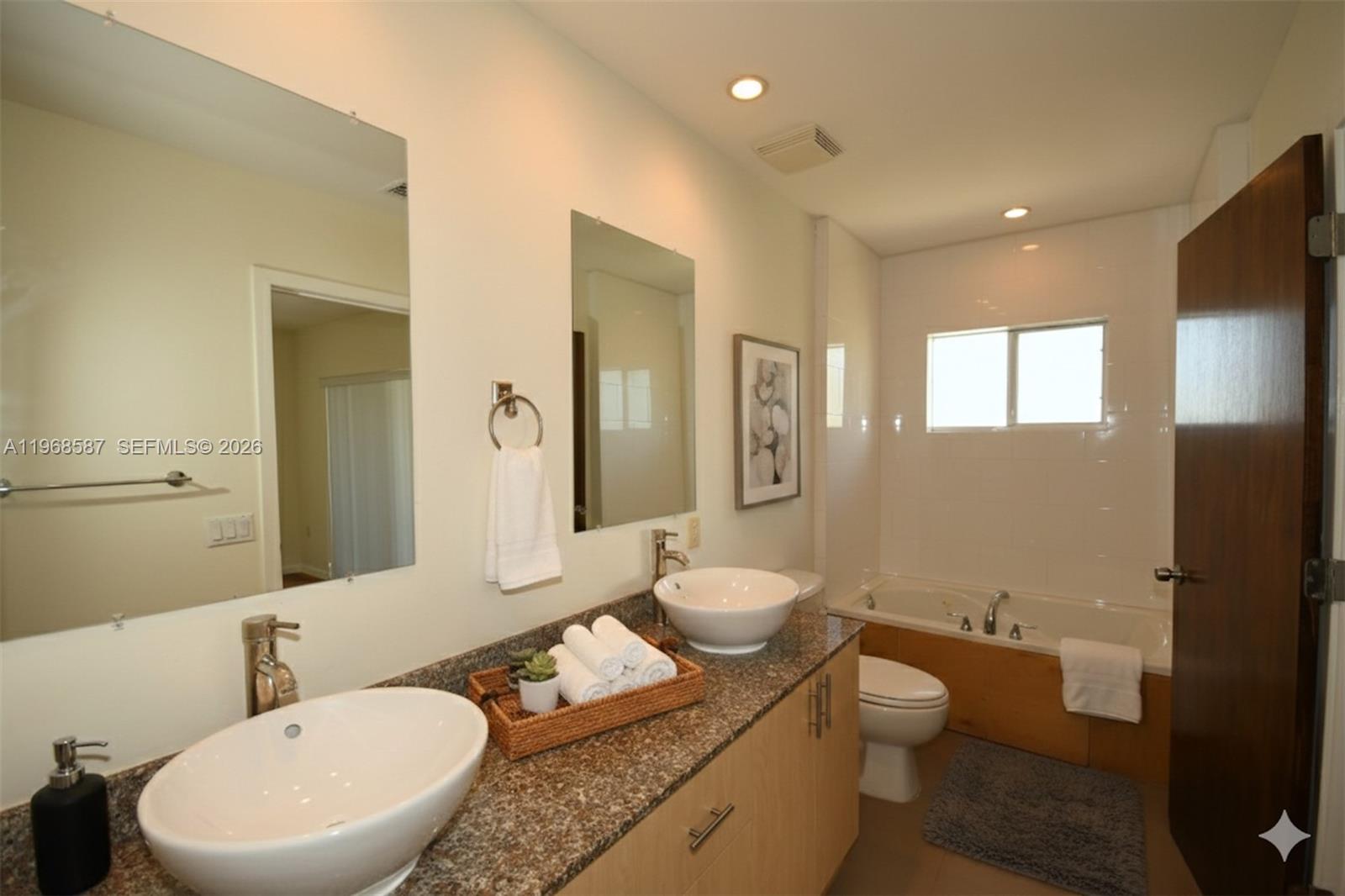 2780 Southwest 33rd Avenue Miami, FL 33133 - Photo 11 of 52 a bathroom with a toilet a sink and mirror