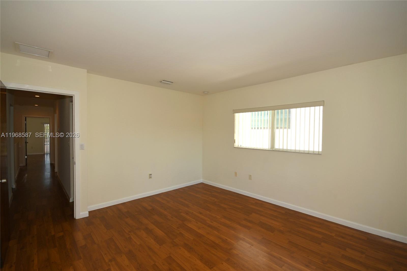 2780 Southwest 33rd Avenue Miami, FL 33133 - Photo 12 of 52 an empty room with wooden floor and windows