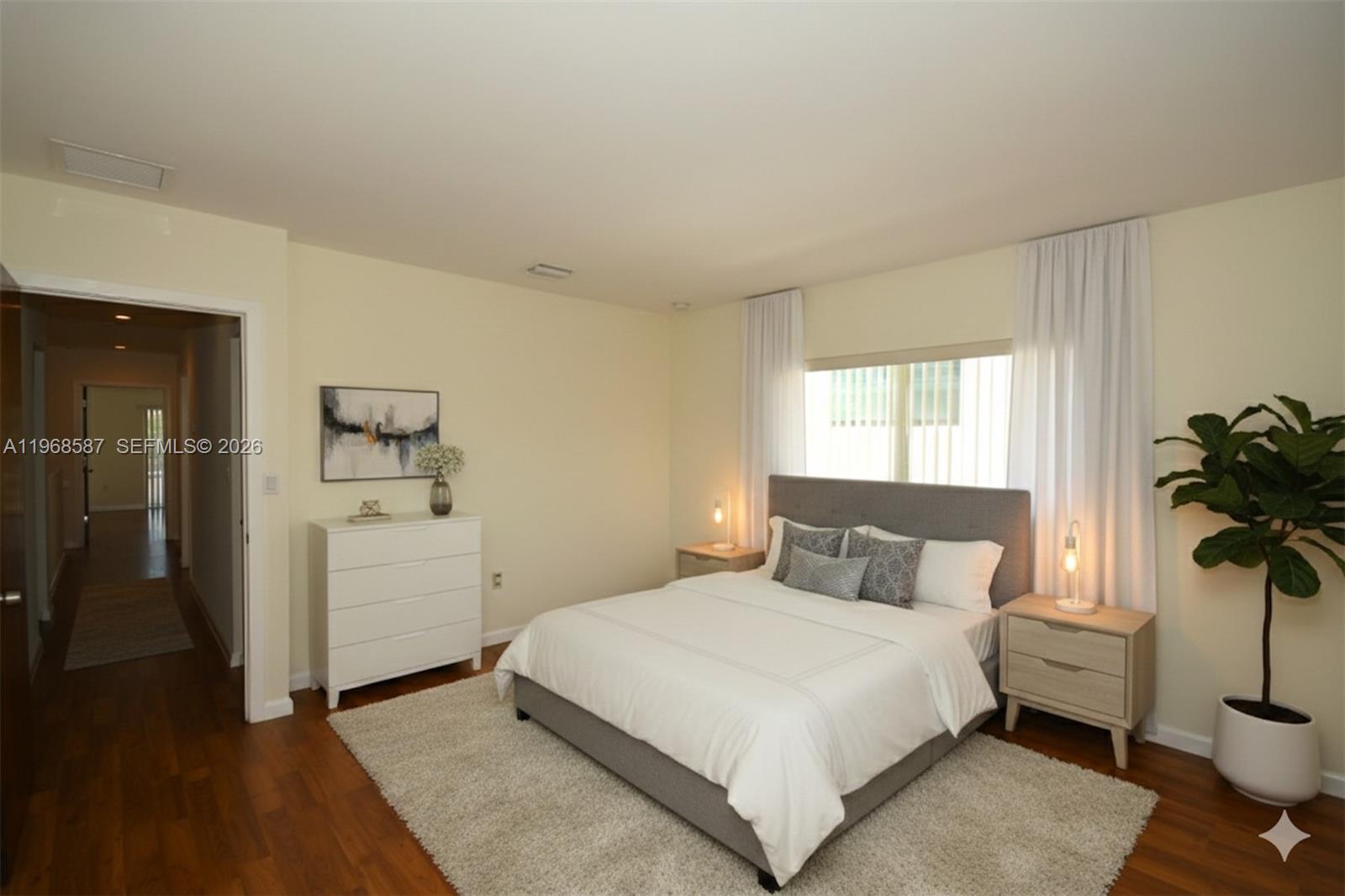 2780 Southwest 33rd Avenue Miami, FL 33133 - Photo 13 of 52 a bedroom with a bed and a potted plant