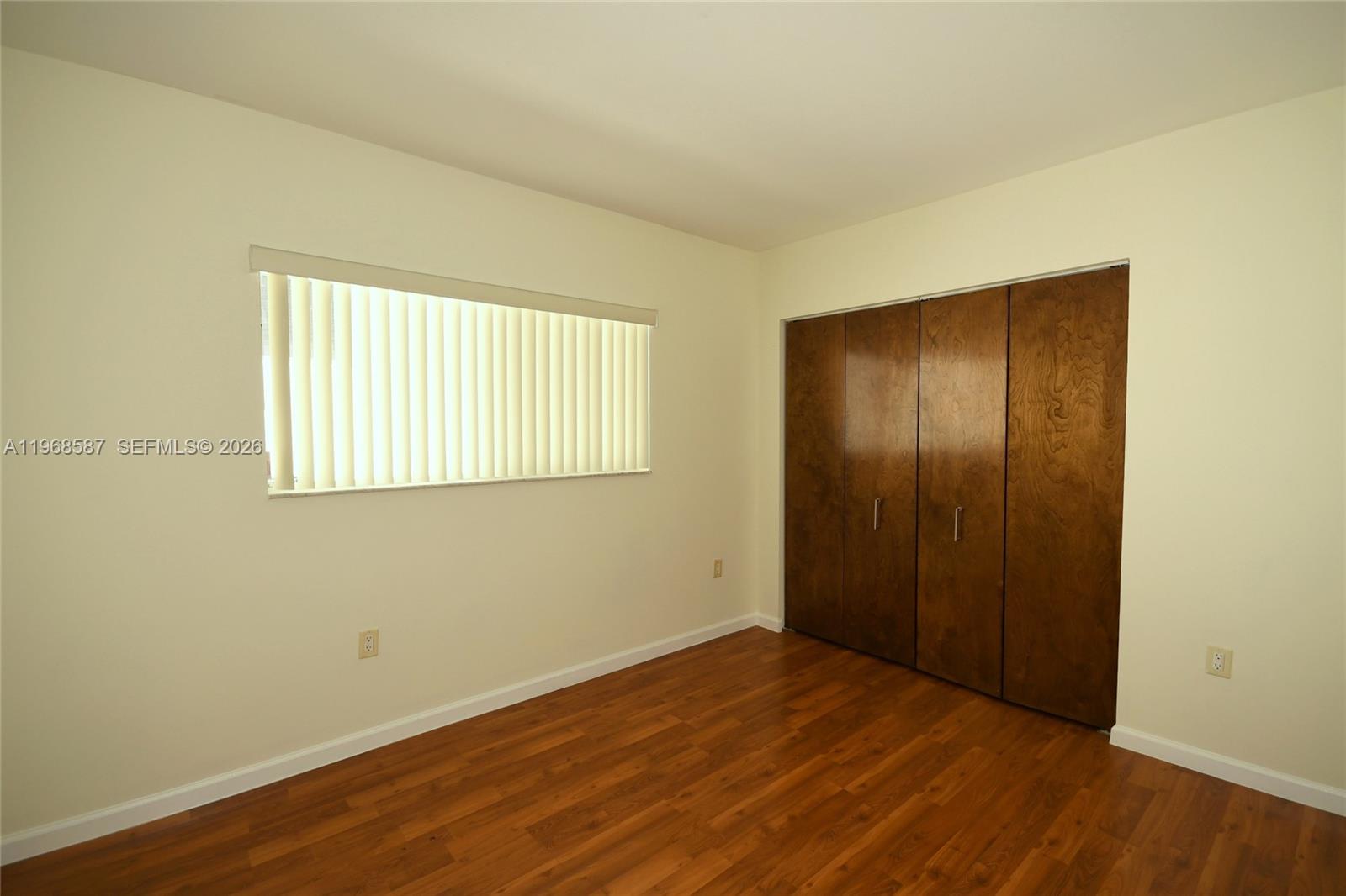 2780 Southwest 33rd Avenue Miami, FL 33133 - Photo 16 of 52 an empty room with wooden floor and windows