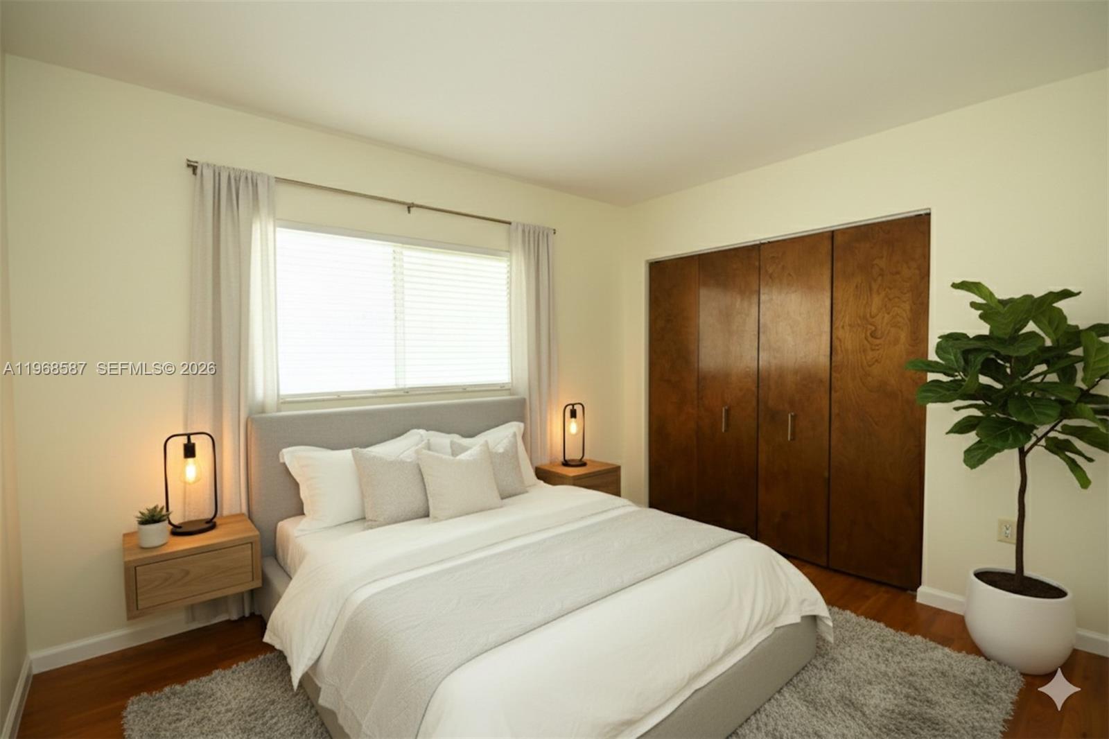2780 Southwest 33rd Avenue Miami, FL 33133 - Photo 17 of 52 a bedroom with a bed and a potted plant