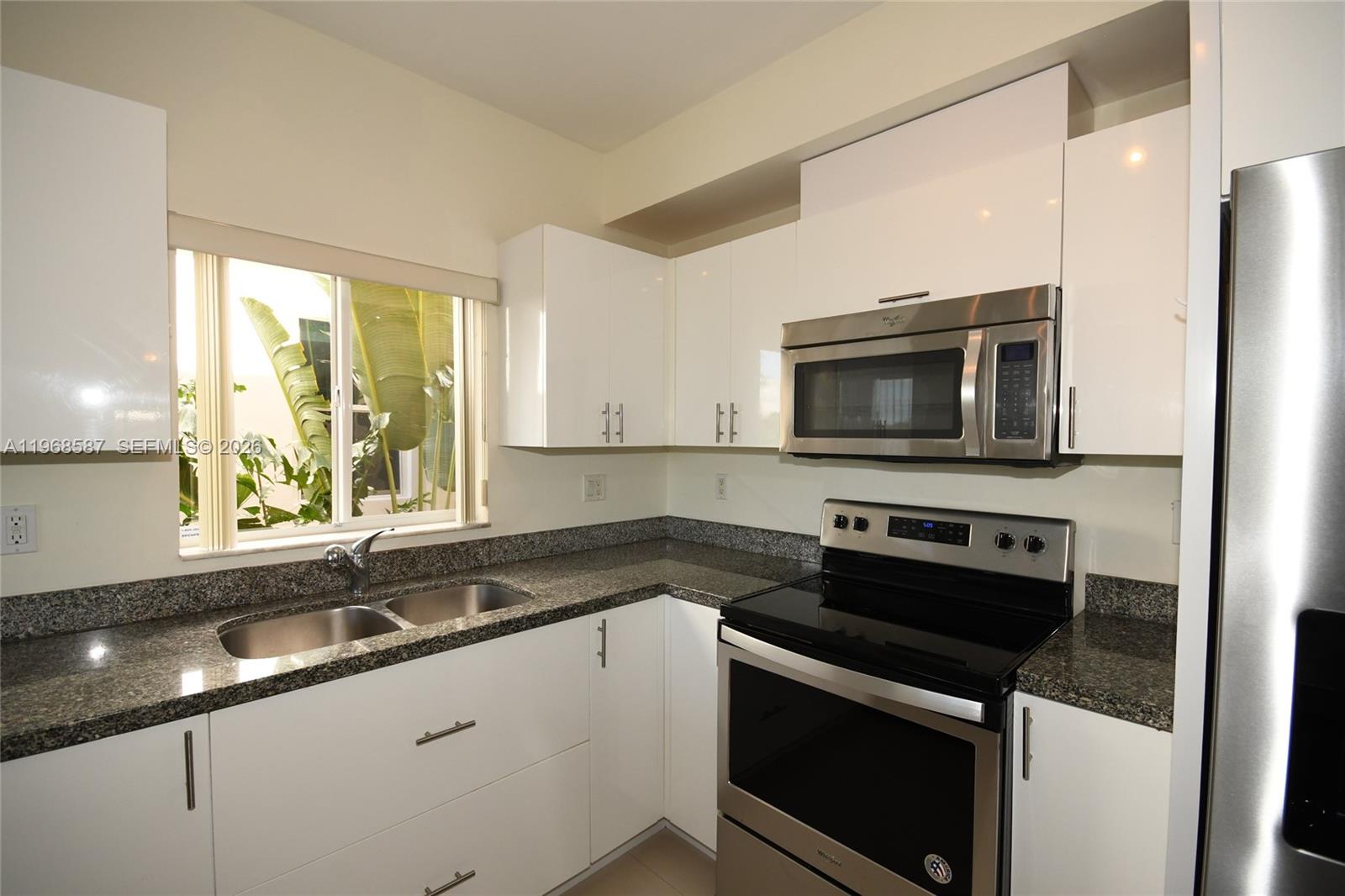 2780 Southwest 33rd Avenue Miami, FL 33133 - Photo 20 of 52 a kitchen with a sink stove and microwave