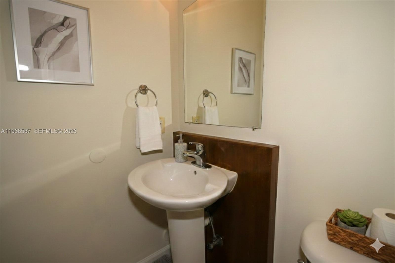 2780 Southwest 33rd Avenue Miami, FL 33133 - Photo 23 of 52 a bathroom with a sink and mirror with toilet