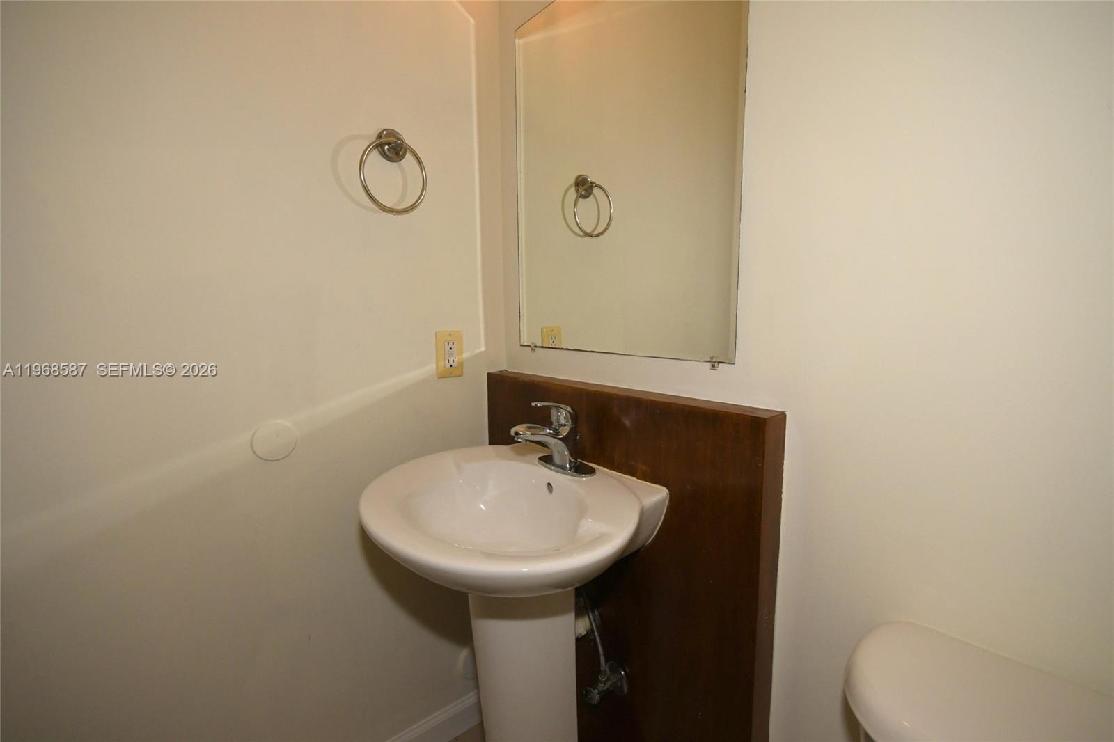 2780 Southwest 33rd Avenue Miami, FL 33133 - Photo 24 of 52 a bathroom with a sink a toilet and mirror